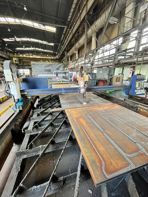 Steel plate with cut contours and holes on the cutting table